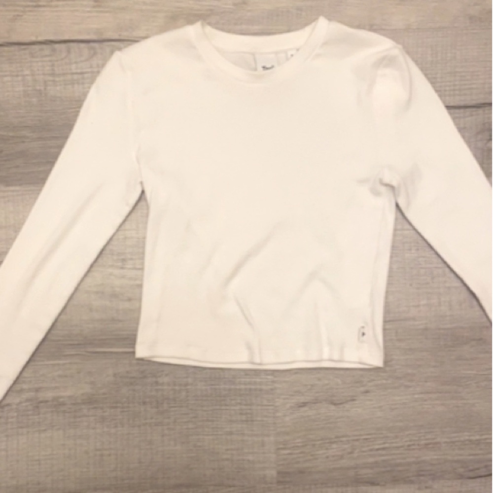 This a white long sleeve, TNA shirt that is still in the stores to this day